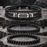 SEYOR three-piece black braided leather and bead bracelet set with silver-tone accents displayed on rugged dark stone.