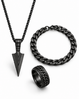 SEYOR men’s black three-piece set featuring an arrowhead pendant necklace, Cuban chain bracelet and engraved band ring on white.