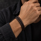 Man wearing a SEYOR coffee-brown double-wrap braided leather bracelet with a minimalist masculine design.