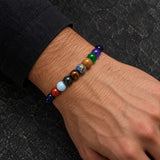 Man wearing a SEYOR multicolor solar system bracelet with planet-inspired beads and dark blue starry stones