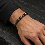 Man wearing a SEYOR adjustable tiger eye bead bracelet with faceted hematite details