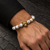 Man wearing a SEYOR white howlite beaded bracelet with an antique gold leopard centerpiece and crystal accents