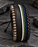 SEYOR men’s layered leather and bead bracelet set in black, white, green, blue and brown displayed on dark stone.