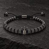 Close-up of SEYOR men's adjustable dark gunmetal bracelet with textured beads and a metallic crown charm