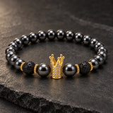 Close-up of SEYOR men's black hematite bead bracelet with lava stones and a gold crystal crown charm