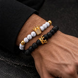 Man wearing SEYOR black lava stone and white marble beaded bracelets with gold crown details
