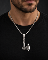 Male model wearing an engraved silver-tone Viking axe pendant necklace with a black T-shirt.