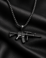 SEYOR men’s black M4 rifle pendant necklace presented on folded textured black leather