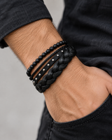SEYOR men’s black four-piece bracelet set with matte beads, braided bands, and silver-tone studs worn on the wrist
