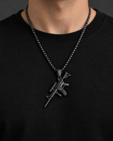 Man wearing a SEYOR black tactical rifle pendant necklace