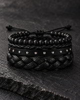 Front view of a SEYOR men’s black bracelet stack with matte beads, textured braids, and silver-tone stud detailing